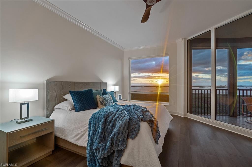 Bedroom featuring wood finished floors, access to exterior, crown molding, and ceiling fan