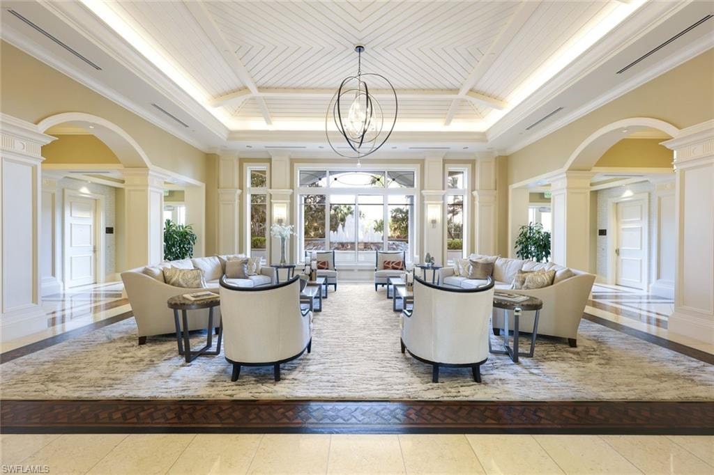 Building lobby with crown molding and a towering ceiling