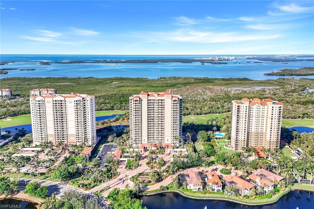 Aerial view of property's location featuring apartment complex and a nearby body of water