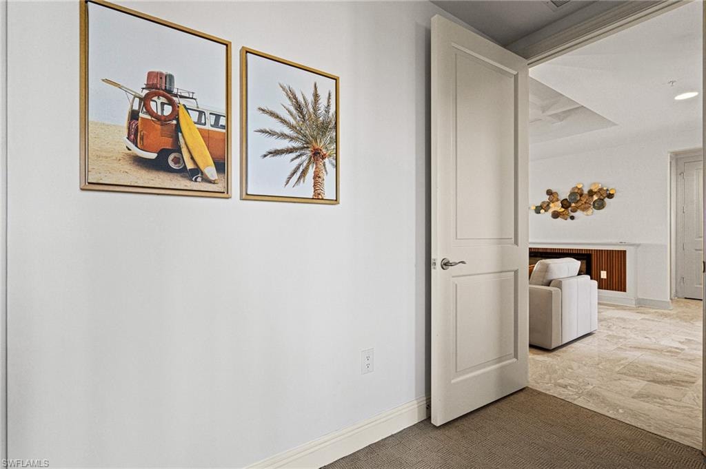 Corridor featuring baseboards and recessed lighting