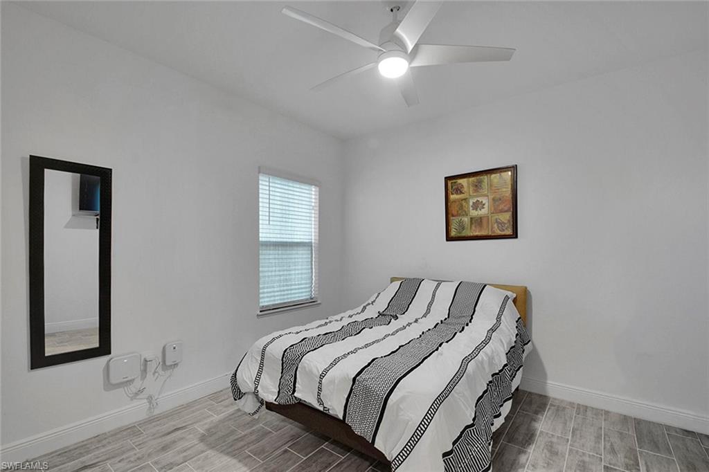 Bedroom with wood tiled floors and ceiling fan