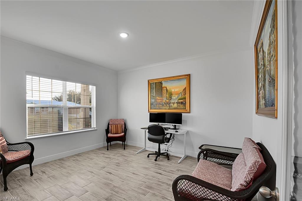 Living area with crown molding, wood finish floors, a desk, and recessed lighting