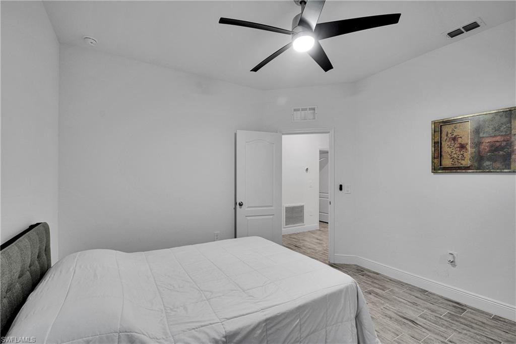 Bedroom with light wood-style flooring and a ceiling fan