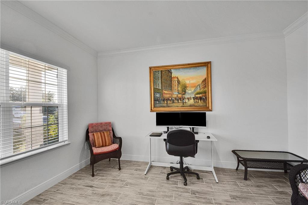 Office with crown molding and wood finish floors
