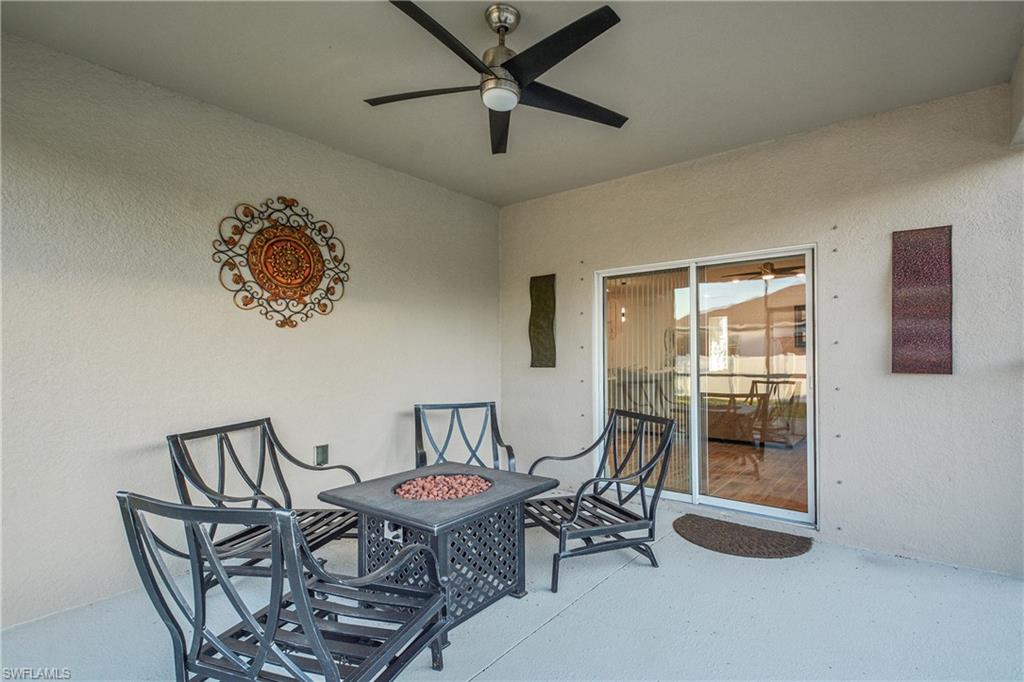 View of patio / terrace with a ceiling fan and a fire pit