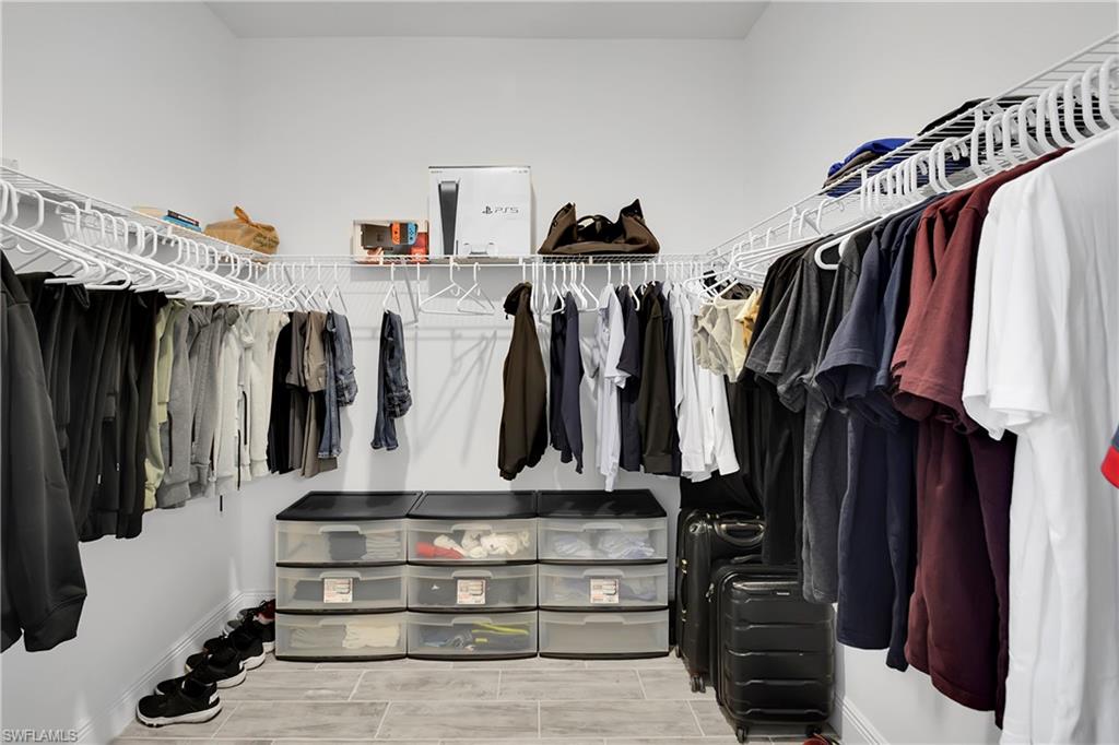 Spacious closet with wood tiled floors