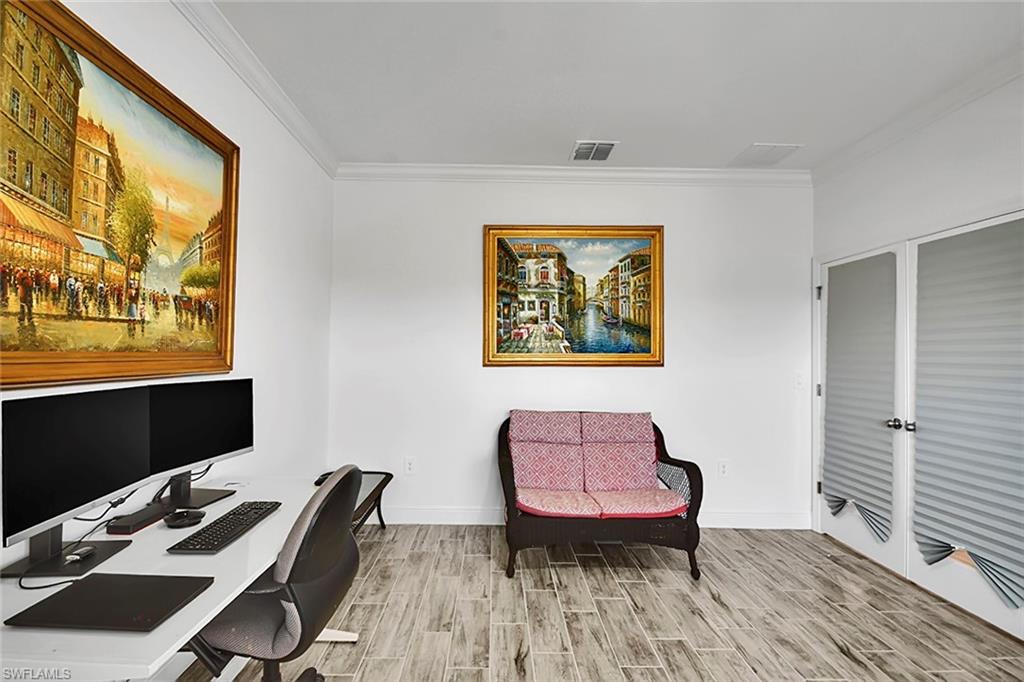 Office space featuring ornamental molding and wood finish floors