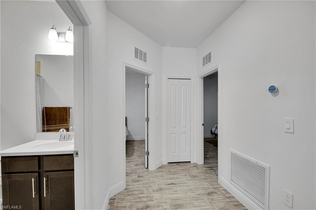 Bathroom featuring vanity and wood tiled floors