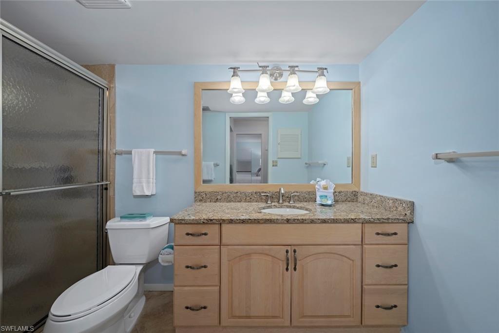 Full bathroom with vanity and a shower stall