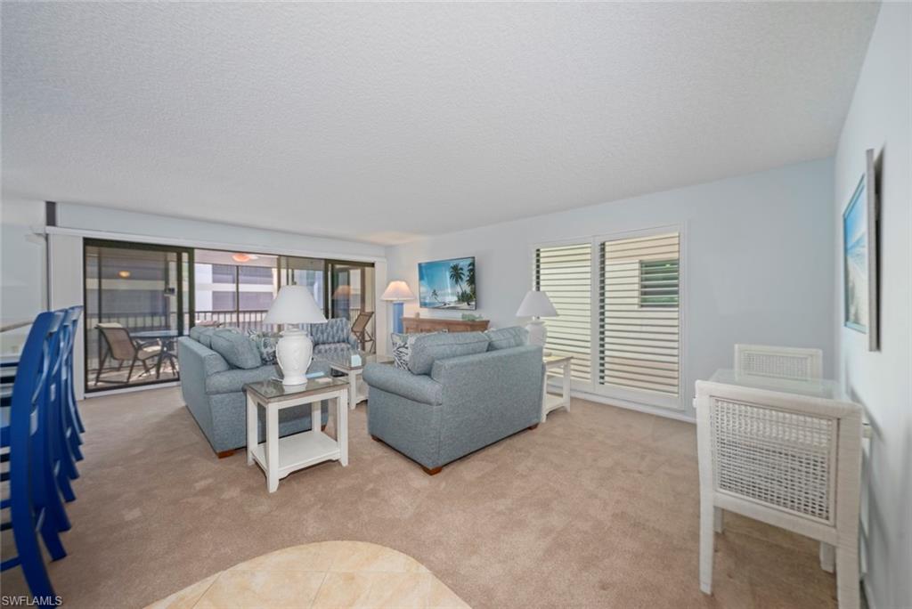 Carpeted living area with a textured ceiling