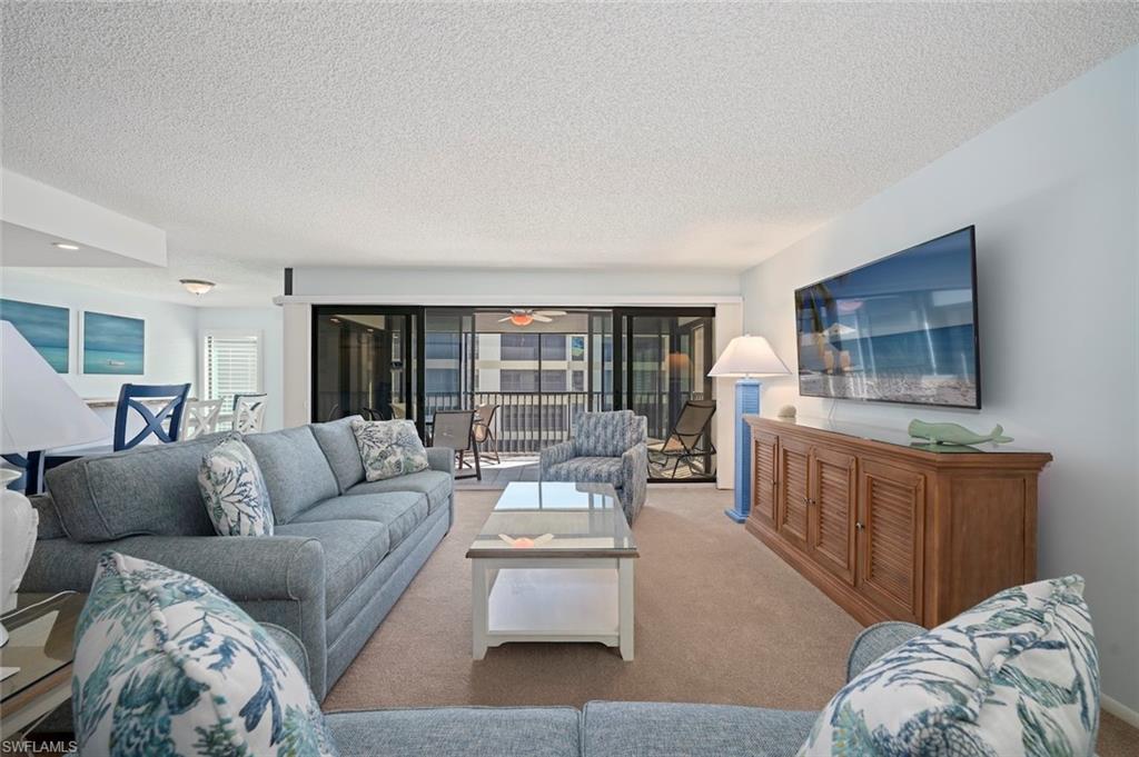 Carpeted living area with a textured ceiling