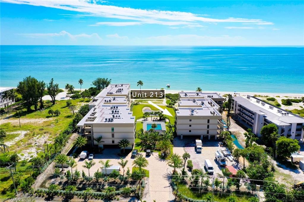 Aerial view of expansive coastline and apartment complex / building