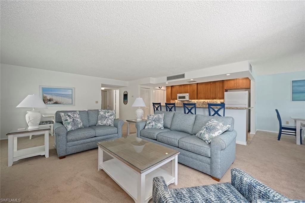 Living room with light carpet and a textured ceiling