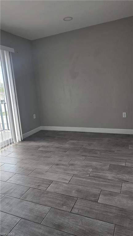 Unfurnished room featuring wood finish floors