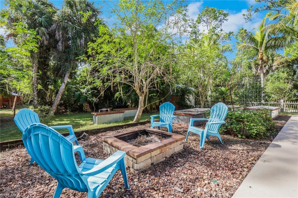 Firepit area and raised garden beds in the backyard off the large patio/pool area- Ideal space for entertaining!