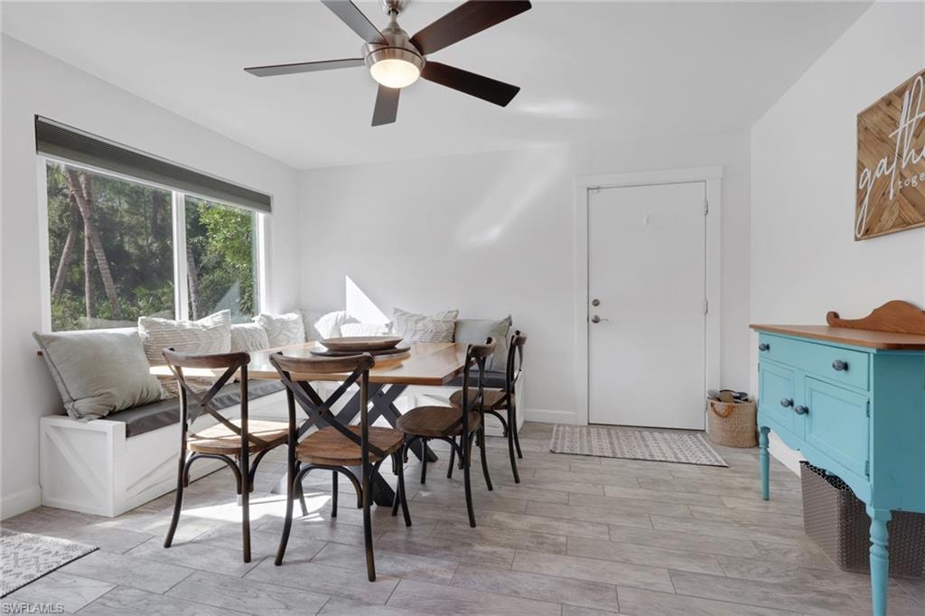 Dining Area off the kitchen with tons of natural lighting and a beautiful view of the pool area, custom built seating that can also be used for added storage