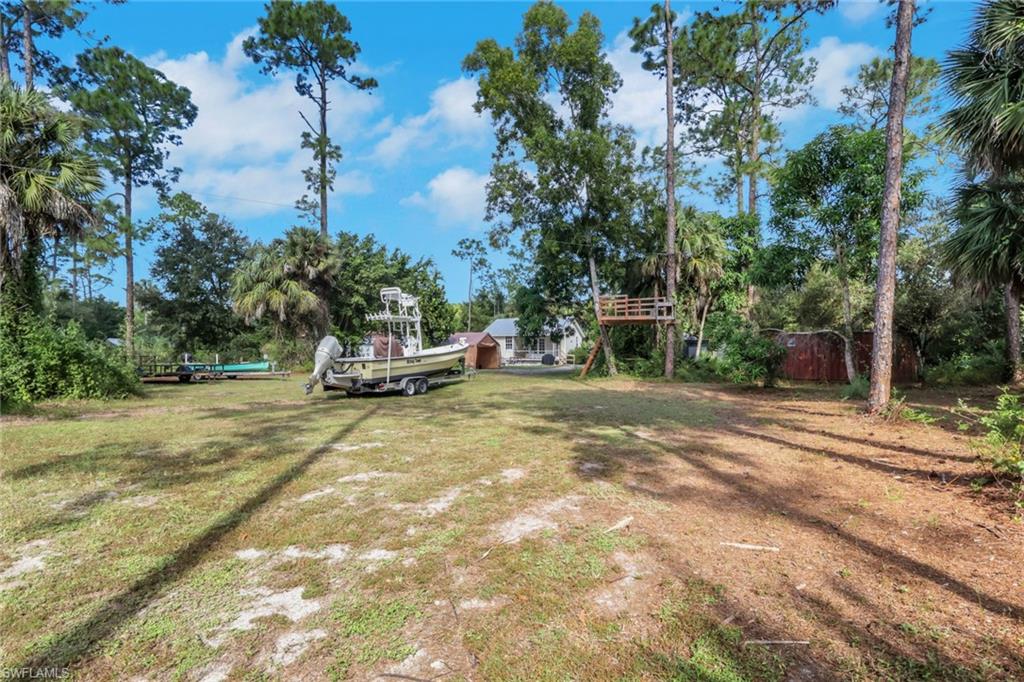 Cleared area in the rear of the lot with a treehouse and zipline! Great space to park your boats, RVS, work trucks, Etc.