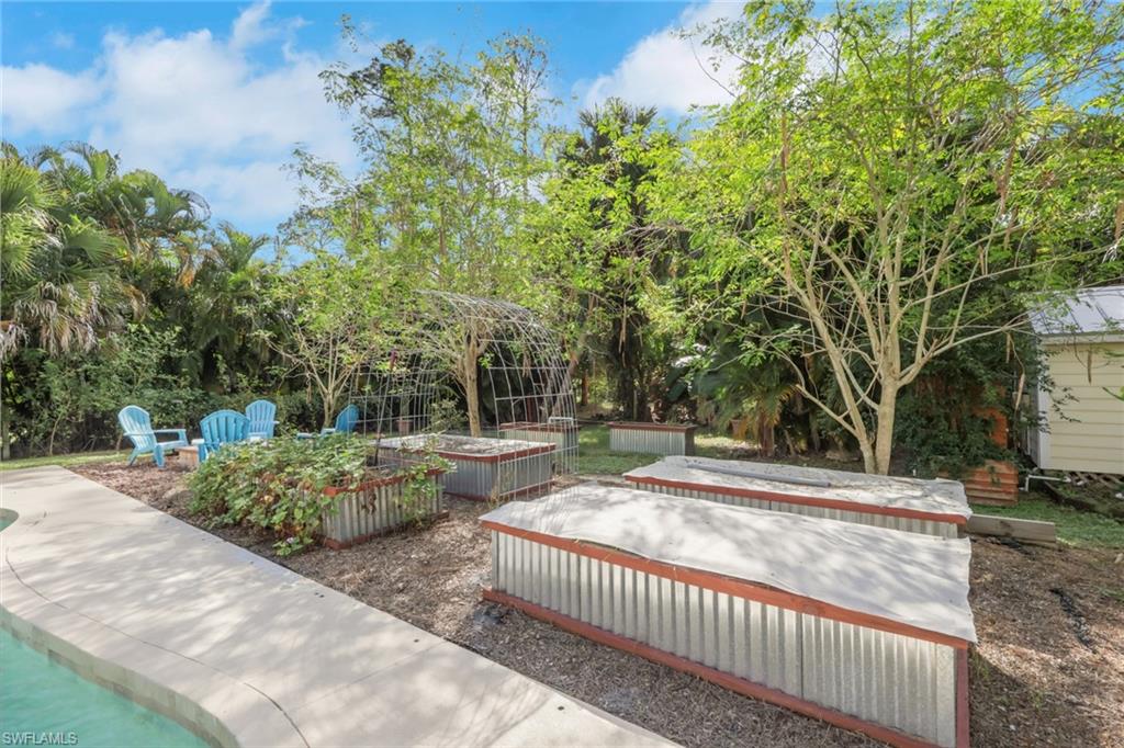 Backyard space with raised garden beds to plant your own fruits and vegetables, firepit, tons of fruit trees throughout the yard, shed, workshop, chicken coop, guest house, and so much more