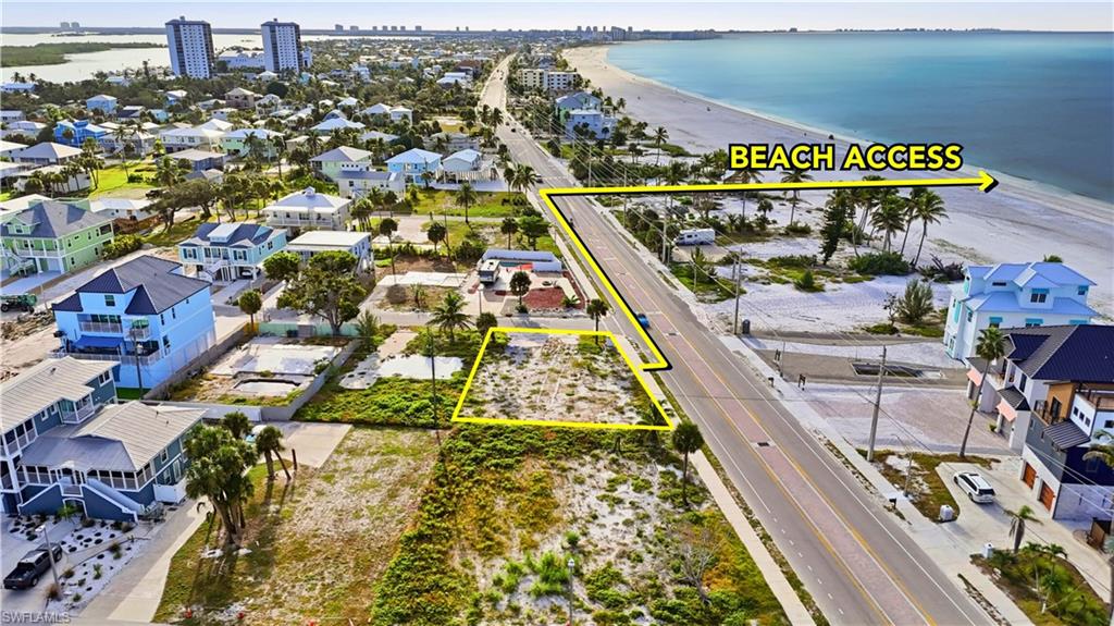 View of urban area with property parcel outlined, a large body of water, and nearby suburban area - Virtually Edited Image