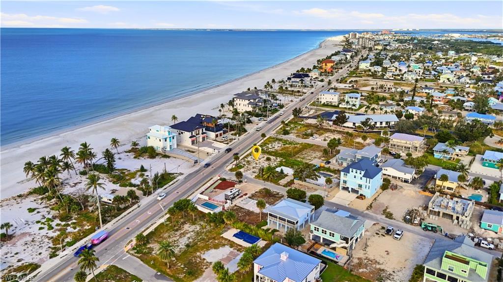 Aerial view of property and surrounding area featuring unending shoreline and nearby suburban area - Virtually Edited Image