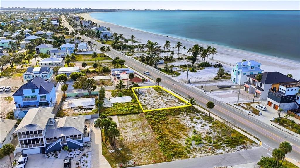 Aerial perspective of suburban area  - Virtually Edited Imagefeaturing property boundaries highlighted and expansive beach
