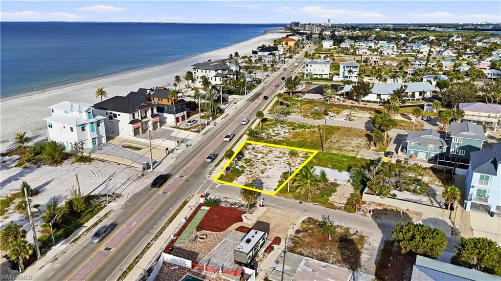 Aerial perspective of suburban area with property boundaries highlighted and unending shoreline - Virtually Edited Image
