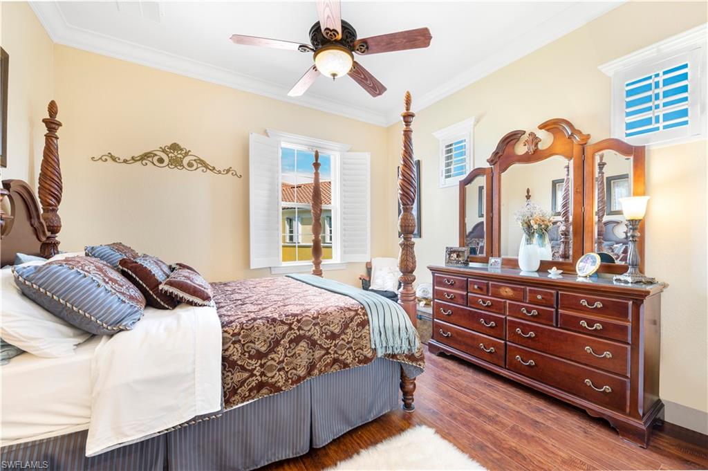 Bedroom featuring crown molding, wood finished floors, and ceiling fan