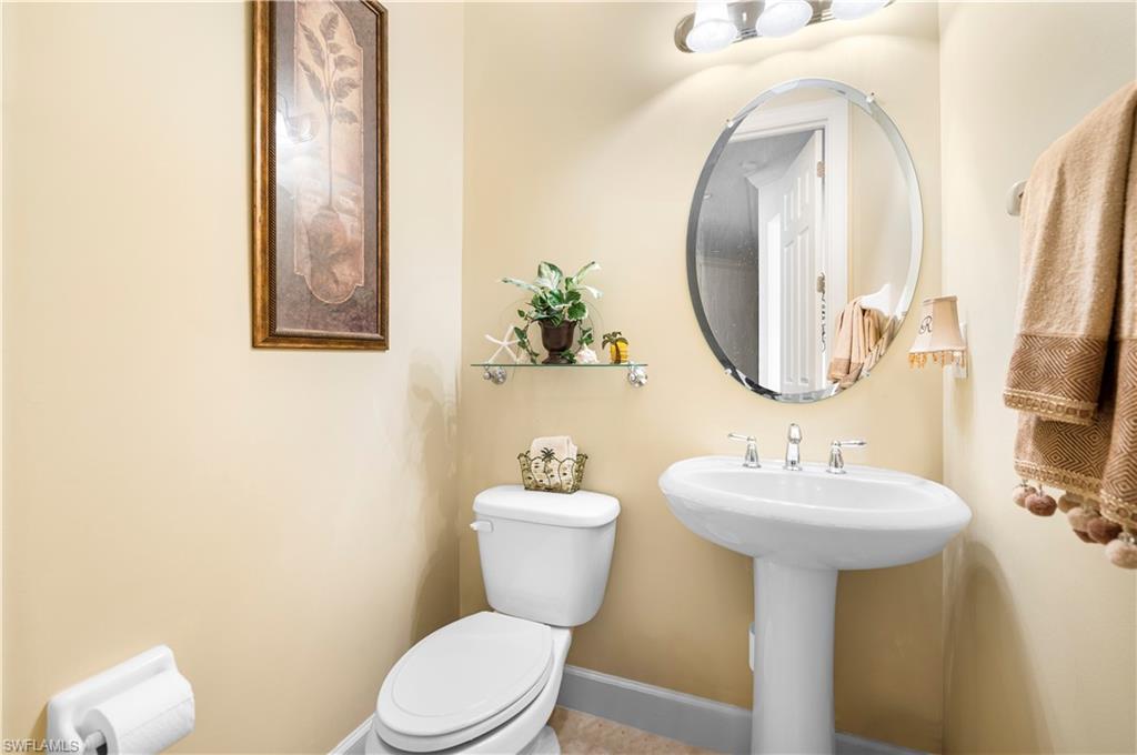 Half bath with toilet and baseboards