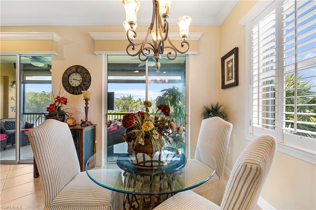 Dining room with crown molding, a chandelier, and tile patterned flooring