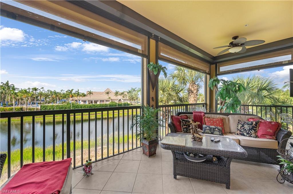 Balcony with a water view, a ceiling fan, and outdoor lounge area