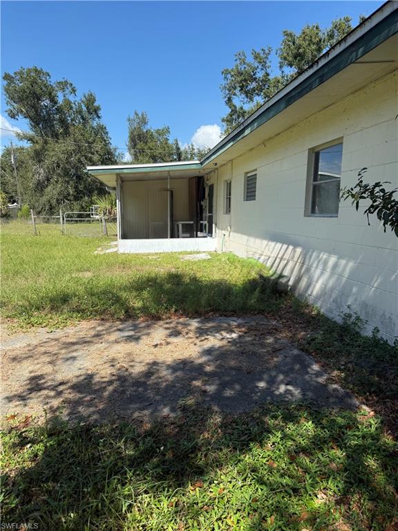 View of yard with a sunroom