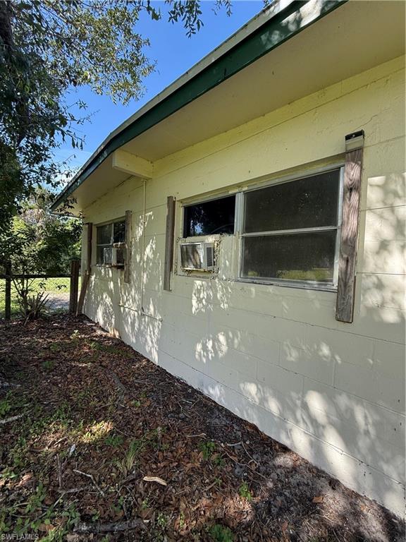 View of side of property featuring concrete block siding