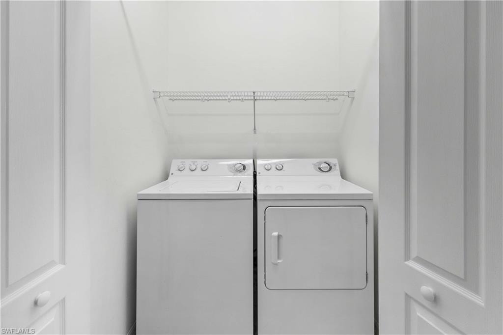 Washroom featuring washing machine and dryer