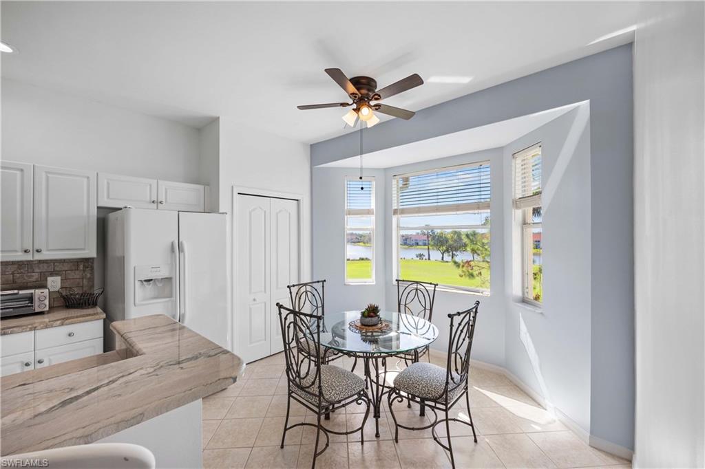 Dining room with ceiling fan and light tile patterned floors