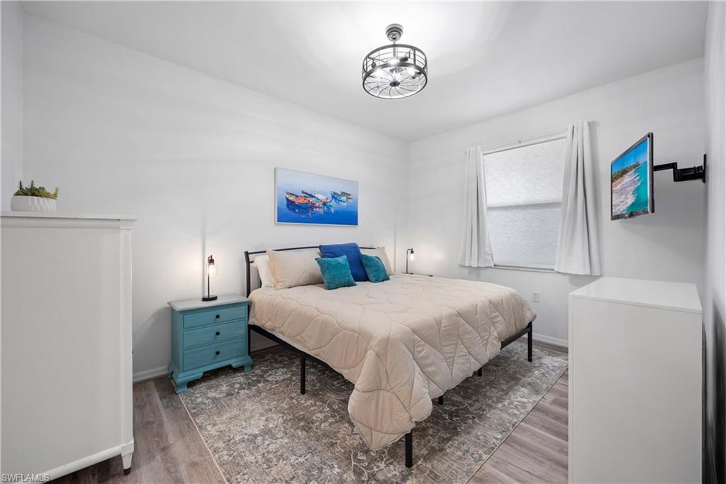Bedroom with dark hardwood / wood-style floors
