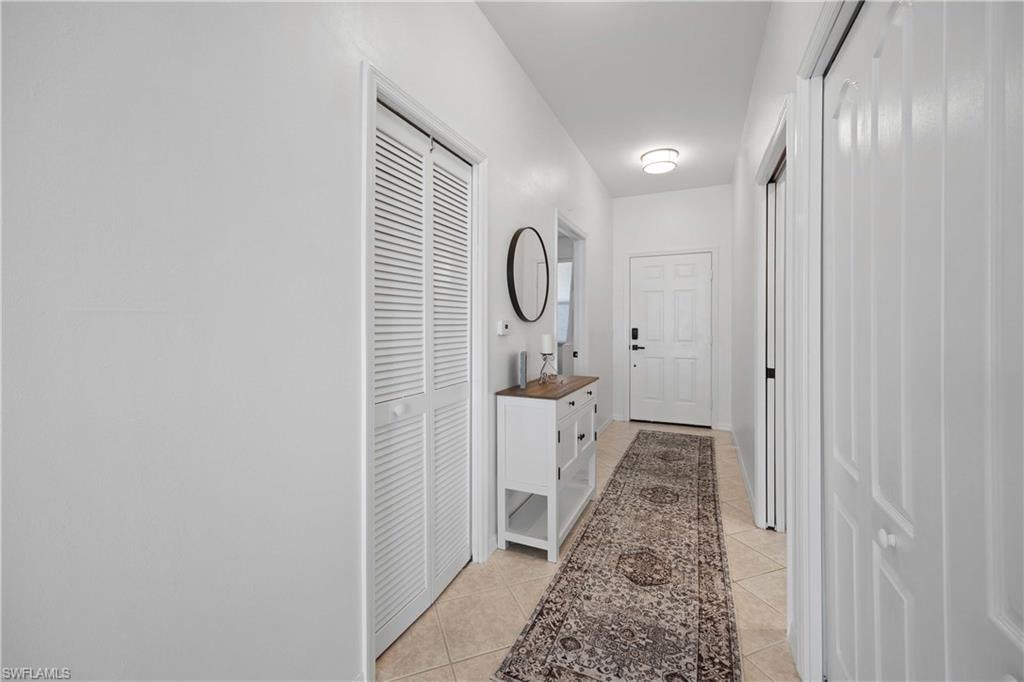 Corridor featuring light tile patterned floors