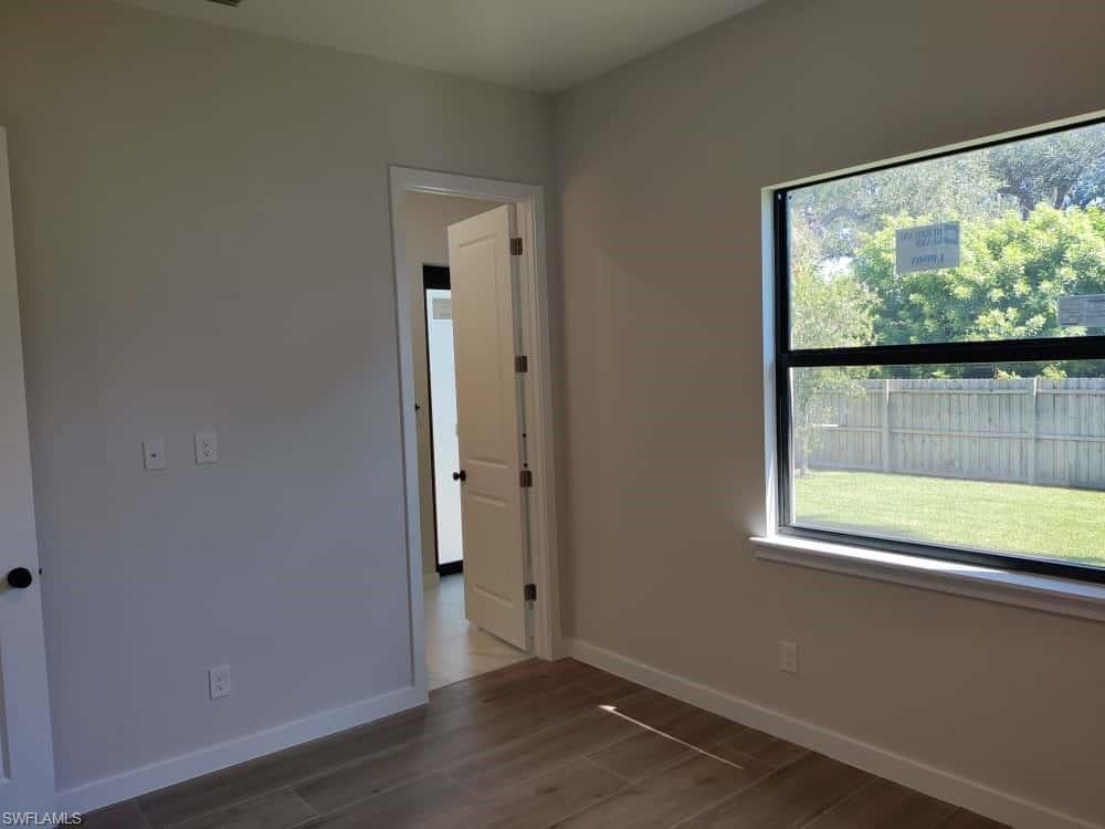 Unfurnished room with dark wood finished floors