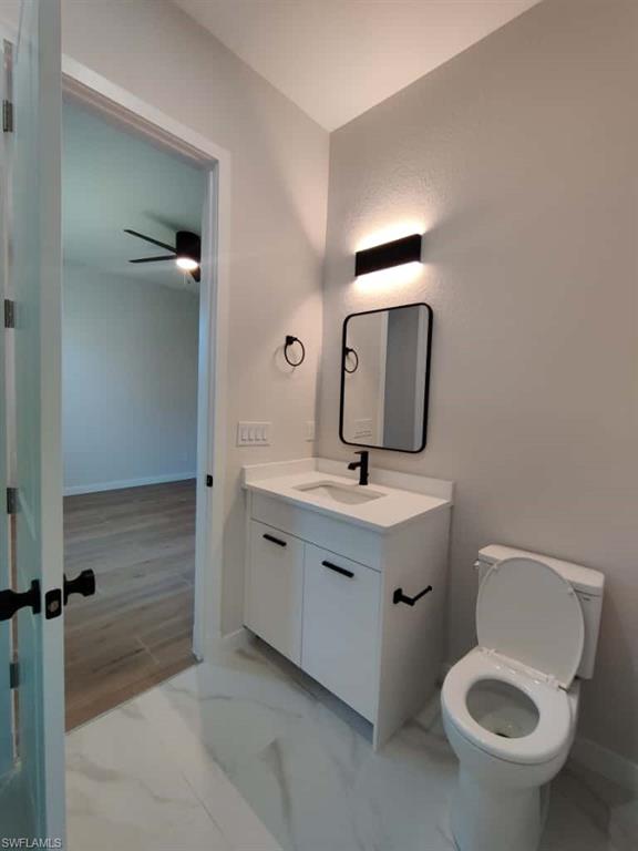 Bathroom with vanity and light marble finish floors