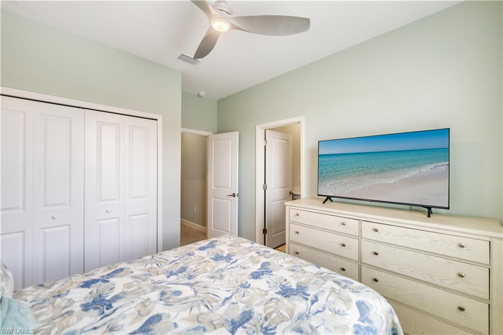 Bedroom with ceiling fan and a closet