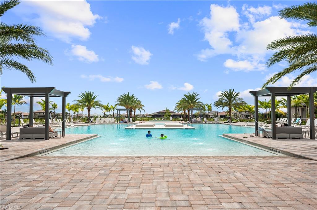 View of community pool featuring zero depth entry