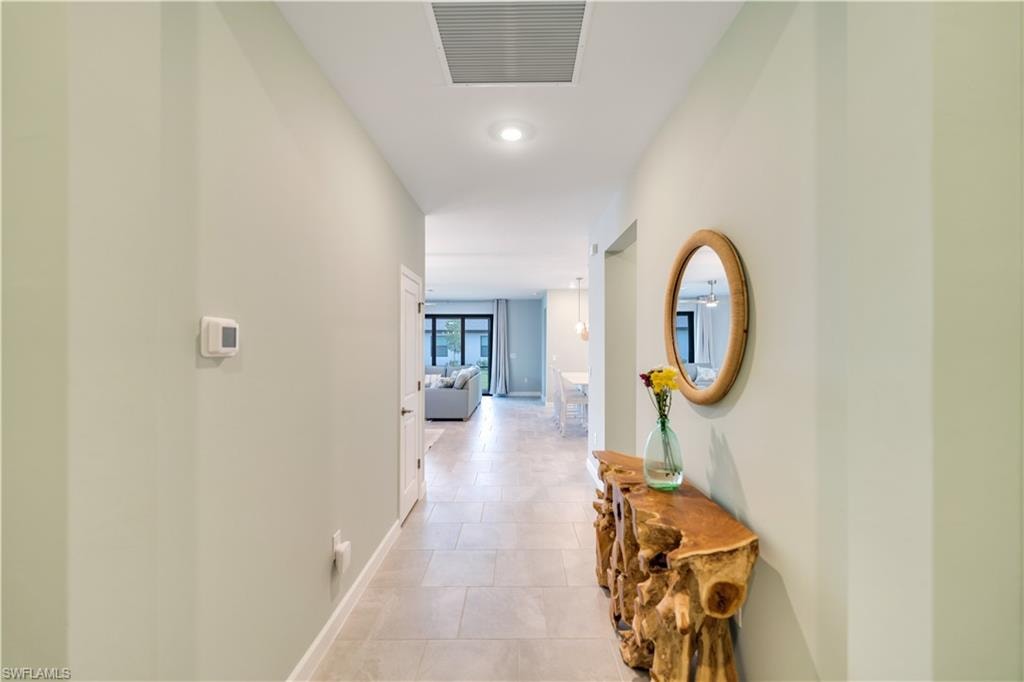 Hall featuring light tile patterned floors