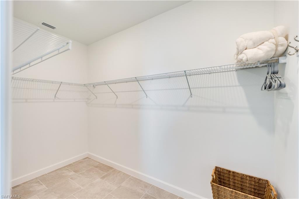 Walk in closet featuring light tile patterned floors