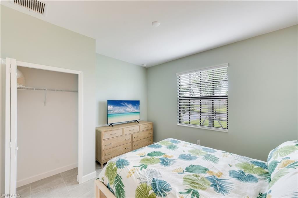 Tiled bedroom with a closet