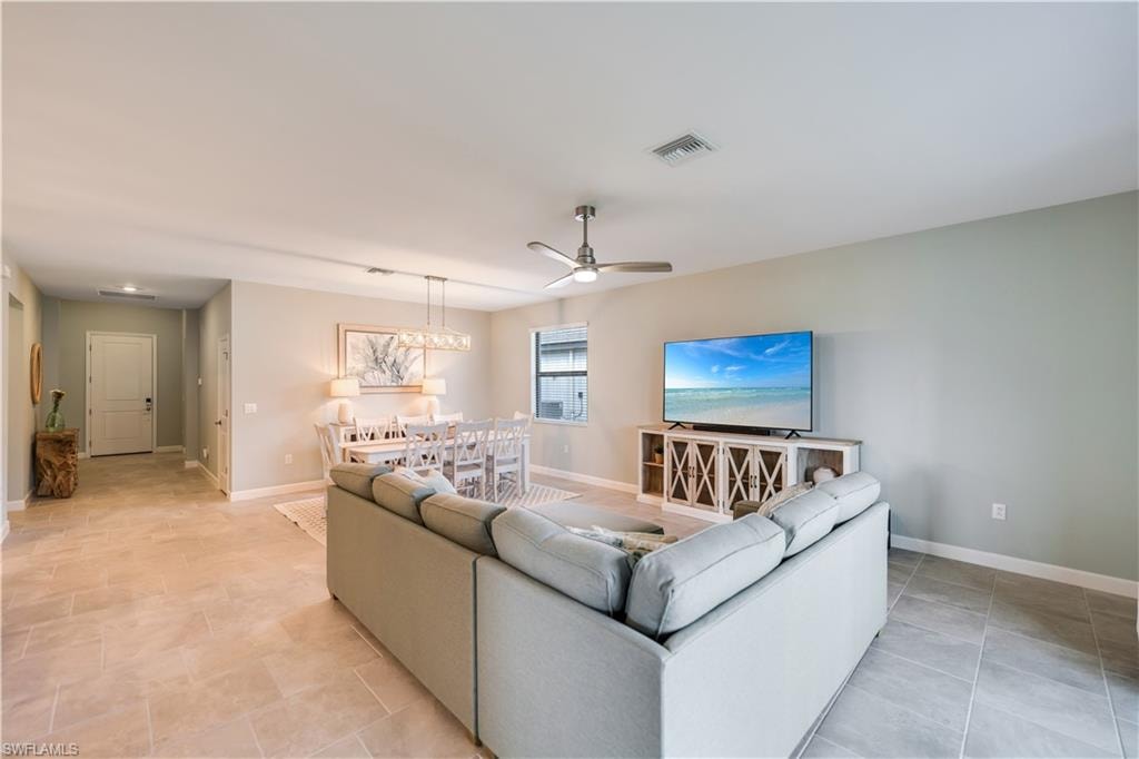 Tiled living room featuring ceiling fan