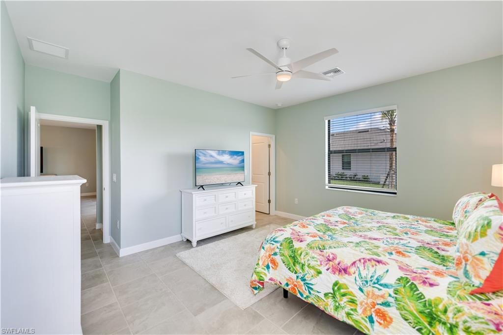 Tiled bedroom with ceiling fan