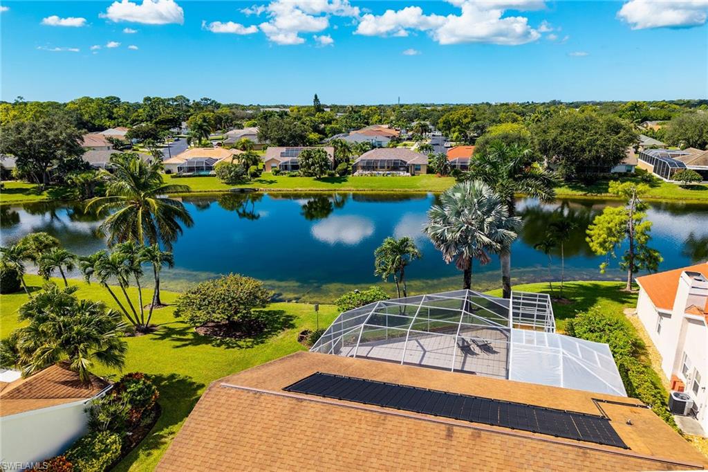 Aerial perspective of suburban area featuring a large body of water