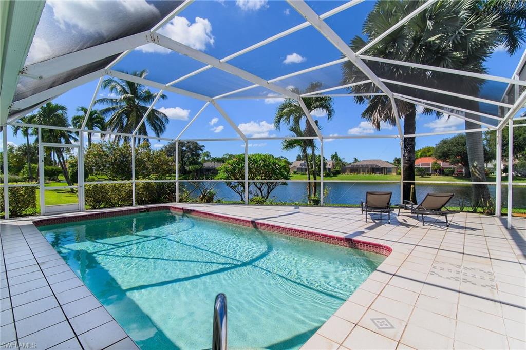 Swimming pool with a lanai, a patio area, a water view, and a sunroom