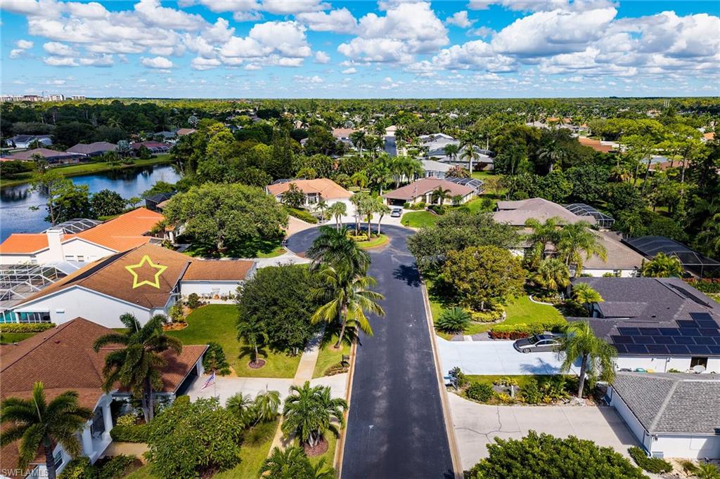 Aerial view of residential area featuring a nearby body of water