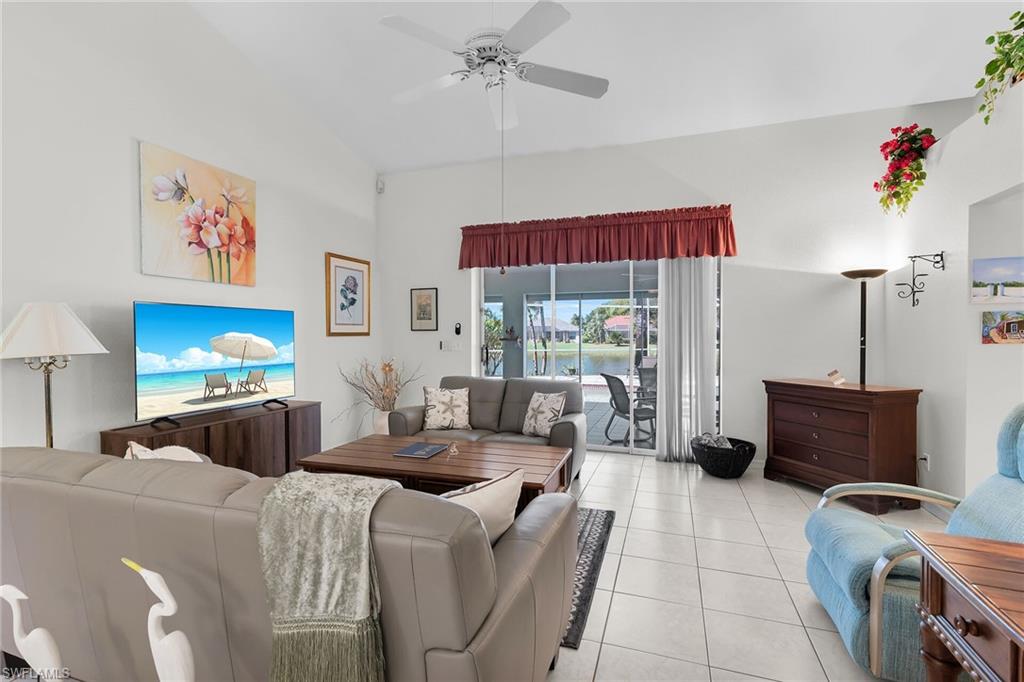 Living room with a ceiling fan and tile patterned floors