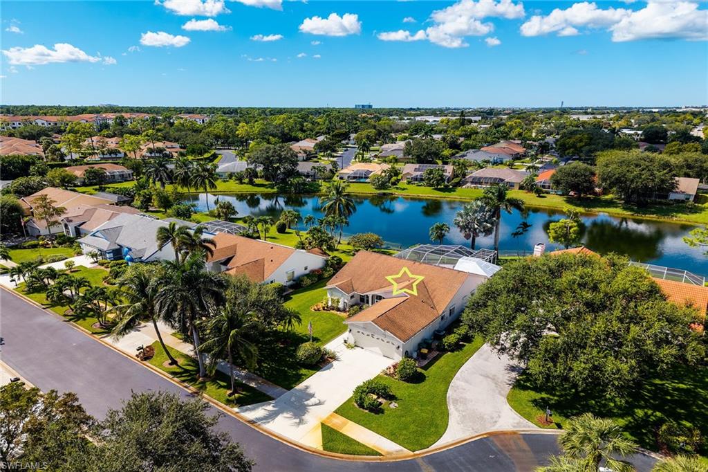 Aerial view of residential area featuring a nearby body of water